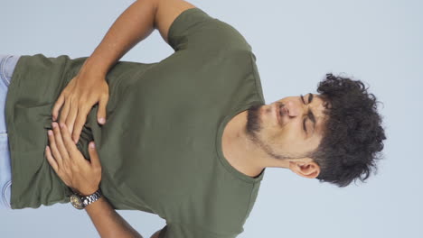 Vertical-video-of-Man-experiencing-stomachache.